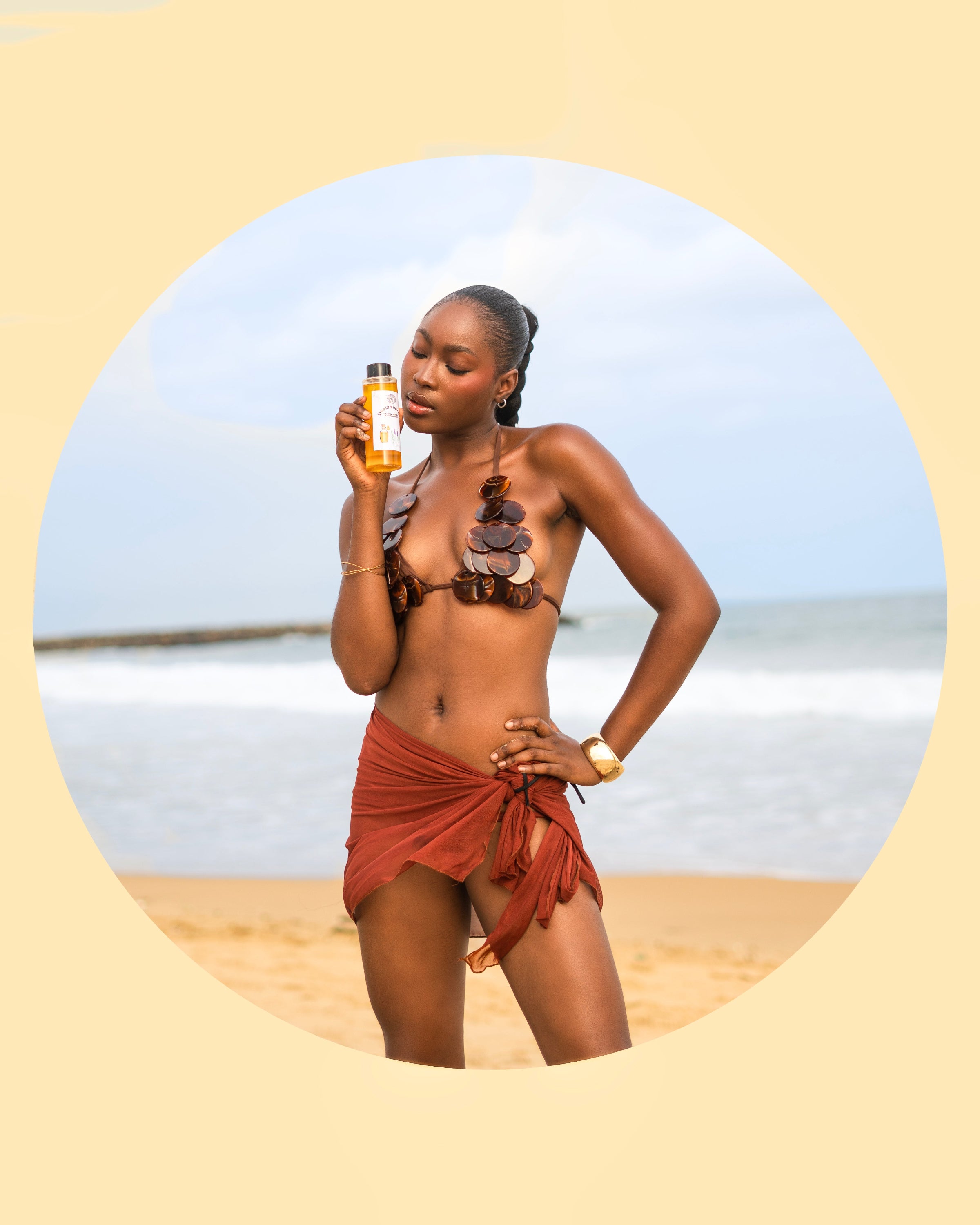 Woman holding a bottle on a beach with a circular overlay
